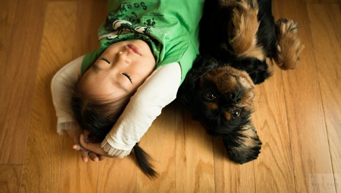 kid with puppy on floor