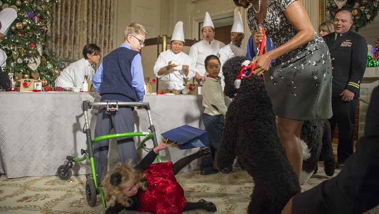 Michelle Obama pulls Sunny back as a little girl falls to the floor.