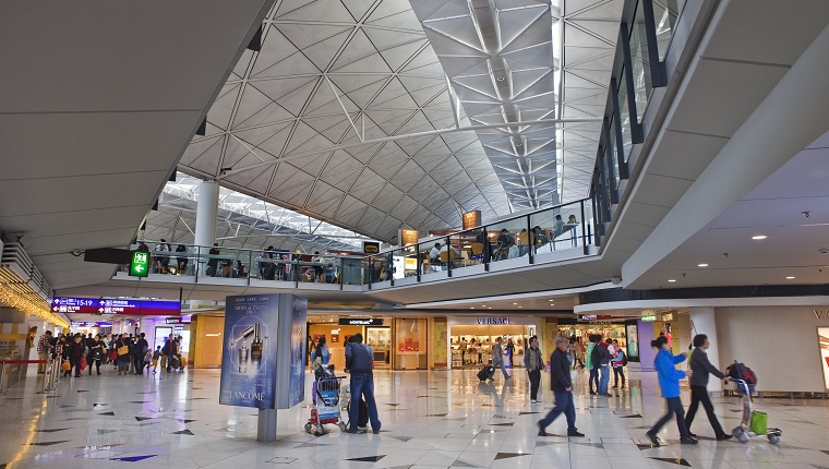 Travelers rush around Hong Kong International Airport.