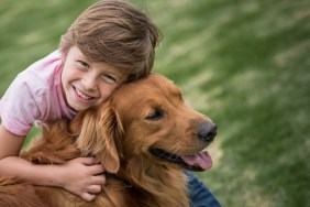 Portrait of a happy boy outdoors with a beautiful dog - lifestyle concepts