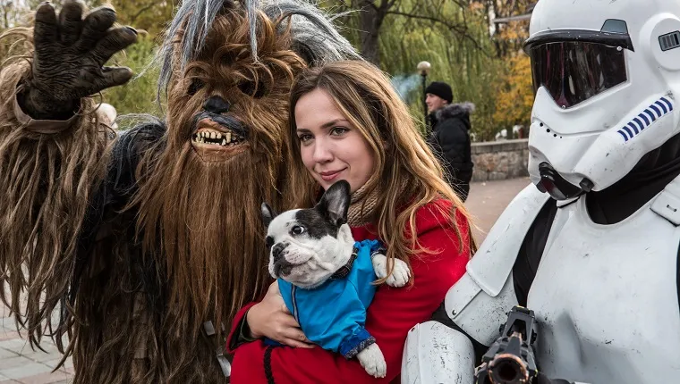 KIEV, UKRAINE - OCTOBER 24: A woman and her dog pose for a picture with representatives of the Internet Party of Ukraine dressed as characters from Star Wars, including parliamentary candidate Stepan Mikhailovich Chewbacca (L), on October 24, 2014 in Kiev, Ukraine. The country's parliamentary elections, scheduled for Sunday, are seen as key to President Petro Poroshenko's ability to advance his agenda, stabilize the economy, and end fighting in the country's east. 