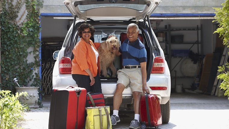Black couple loading car for vacation