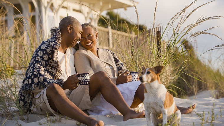 Senior African American couple sitting on beach
