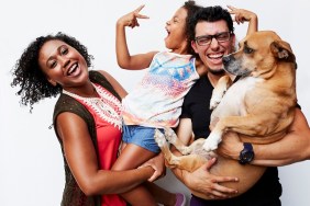 Man and woman holding daughter and dog