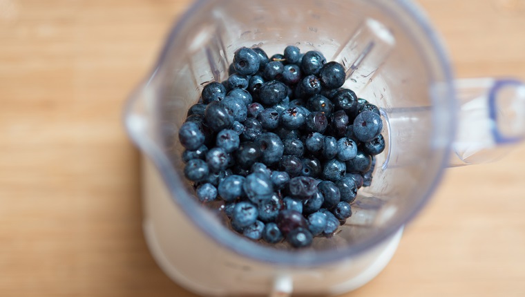 Ripe blueberry in a bowl of electric mixer, view from above