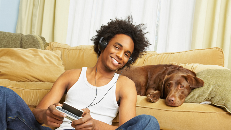 man listening to podcasts with dog