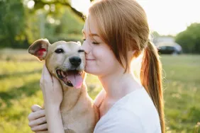 woman hugging dog health basics