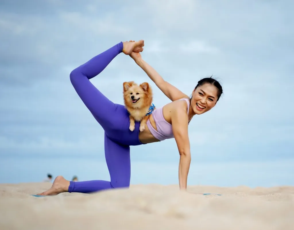 woman doing yoga or doga with dog