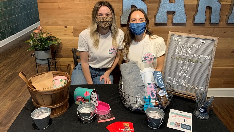 IAATP Founder & President Erika (right) and IAATP volunteer (left) manned the raffle, items for purchase, and goodie bag giveaway at Cafe & Barr, for the drop-in portion of the 5k event.