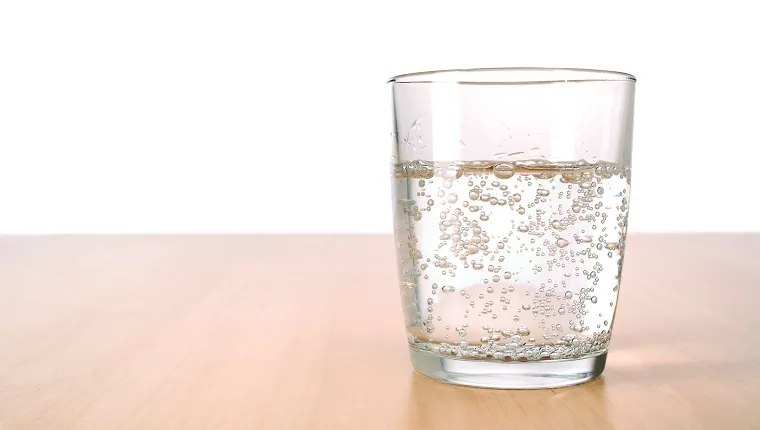 Glass of sparkling water on table