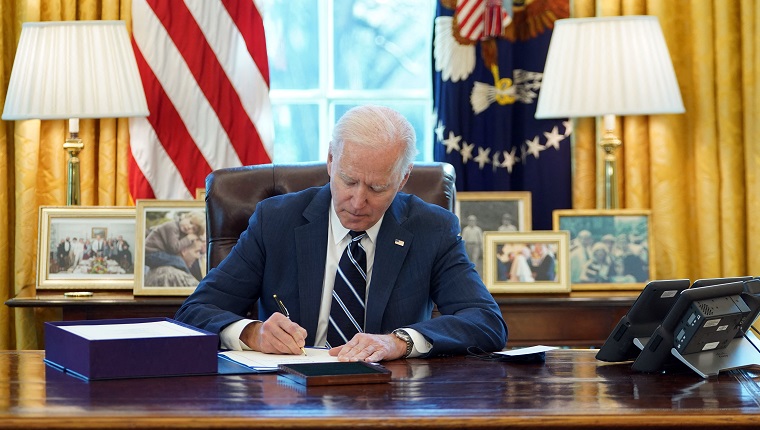 US President Joe Biden signs the American Rescue Plan on March 11, 2021, in the Oval Office of the White House in Washington, DC. - Biden signed the $1.9 trillion economic stimulus bill and will give a national address urging "hope" on the first anniversary of the start of the coronavirus pandemic. (Photo by MANDEL NGAN / AFP) 
