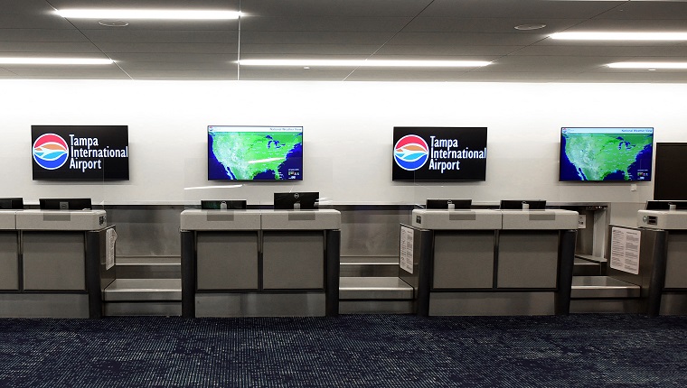 FLORIDA, UNITED STATES - JULY 7: An empty ticket counter with weather maps displayed is seen at Tampa International Airport which closed from 5:00 p.m. until 10:00 a.m as Tropical Storm Elsa moves northward toward the Tampa Bay area on July 6, 2021 in Clearwater Beach, Florida, United States. Storm is expected to make landfall on Florida's Gulf Coast as a Category 1 hurricane early Wednesday morning.