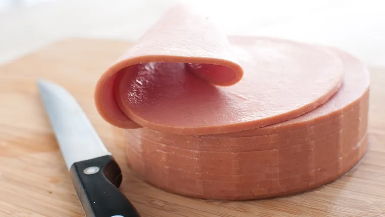 Bologna sausage thin sliced cut with knife