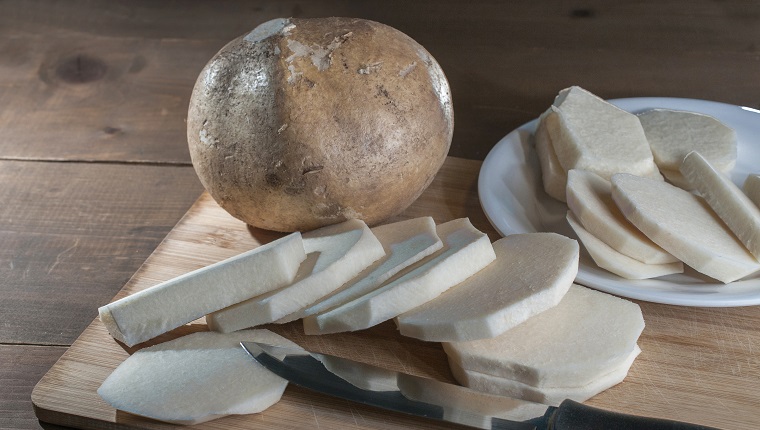 slices of jicama, yam bean, mexican yam bean, tubers or Pachyrhizus erosus on a cutting board