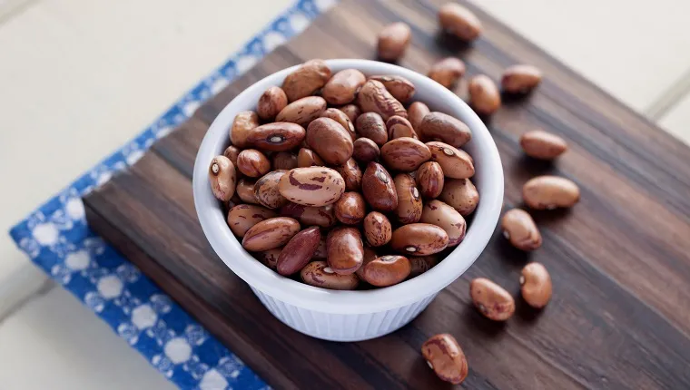 Close-Up Of Pinto Beans In Bowl On Cutting Board