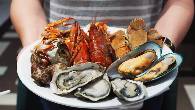 Plate of steamed crayfish, giant river prawn, mussel, giant crab and fresh oyster. Seafood buffet line.