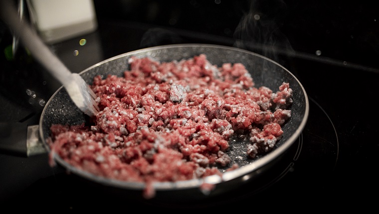 Preparing Bolognese. Step one: Mince beef being boiled in a pan.