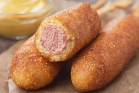 Home made corn dog fried sausage skewer with mustard