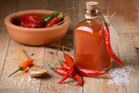 tabasco sauce in the bottle with chili around