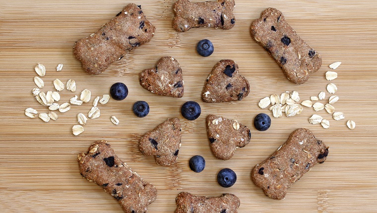 Homemade blueberry, oat, and peanut butter dog biscuits. Top view, macro.