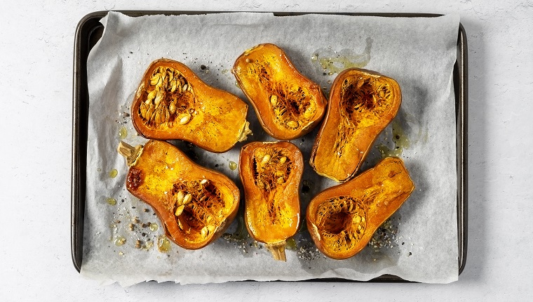 Tray of roasted butternut squash on white background