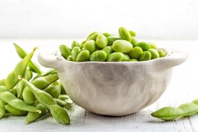bowl of green beans on white wooden table