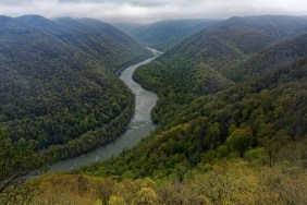 I'd Rather Have a Time Out for Behavior in New River Gorge National Park & Preserve. A view looking to the east to the New River with the river valley and gorge while walking the Grandview Rim Trail in that part of the national park. My thinking in composing the image was to one minimize the overcast skies with low clouds and two create a more sweeping view across this national park landscape by angling my Nikon SLR camera slightly downward. In some ways, the river would be that leading line into the image. I later worked with control points in DxO PhotoLab 4 and then made some adjustments to bring out the contrast, saturation and brightness I wanted for the final image.