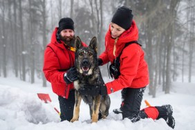 Avalanche Dog with rescue team posing for photo