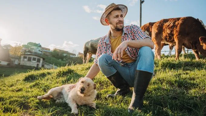 farmer with dog best dog breeds for your homestead
