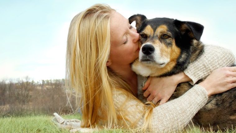 woman hugging dog best prayers for sick dogs