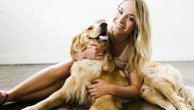 woman hugging golden retriever best dog breeds for an aquarius