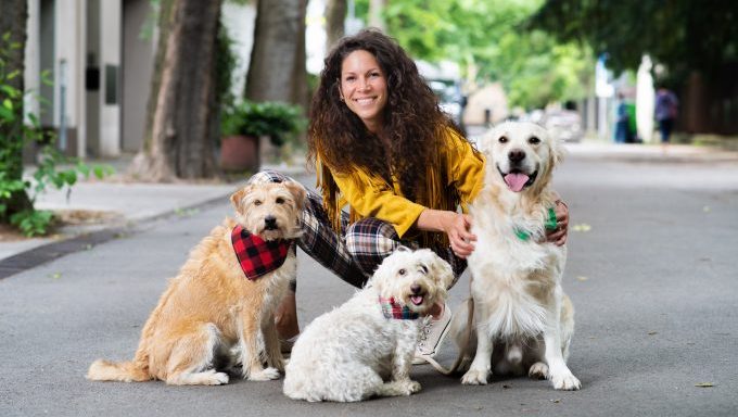 woman with three dogs in city where best dog owners live