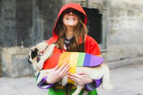 woman and pug in rainbow clothing celebrate pride month with your dog