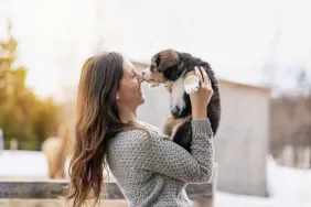 woman who wants to adopt a dog holding a puppy