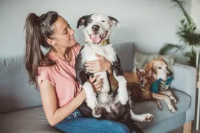 pet sitter hugging dog on couch viral dog nanny ad