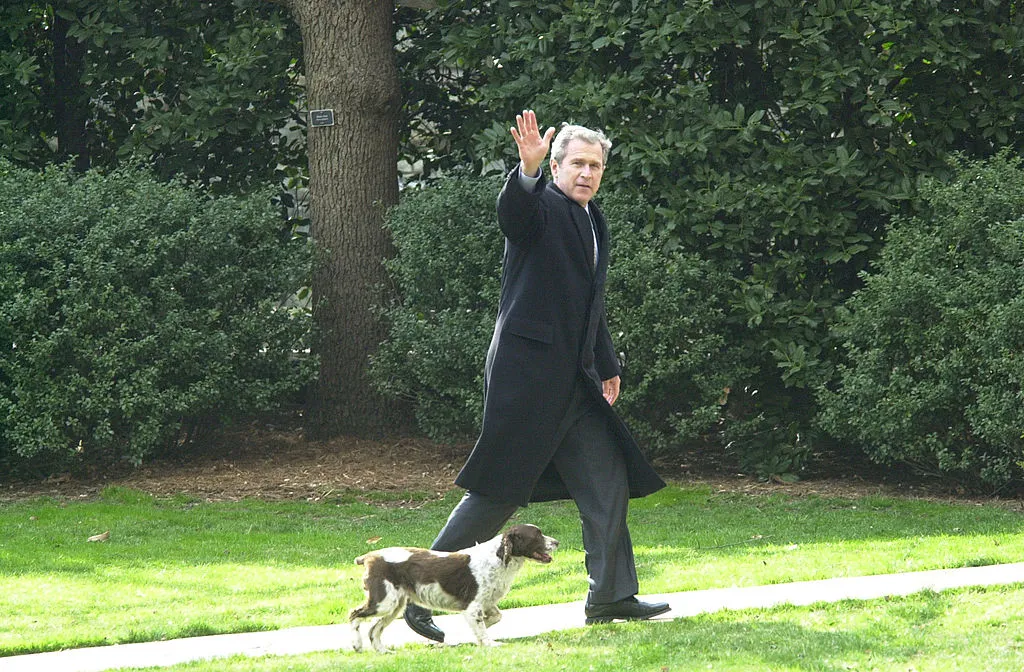 President George W. Bush and his dog Spot walking towards the Oval Office of the White House.