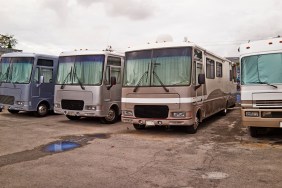 Line of RVs parked in a parking lot.