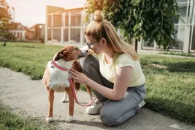 woman adopting a dog at shelter