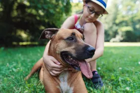 young girl with her dog at off-leash dog park