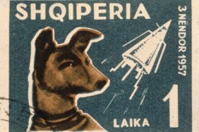 1957: An Albanian postage stamp depicting Laika, the dog sent into space on the Russian space satellite Sputnik.