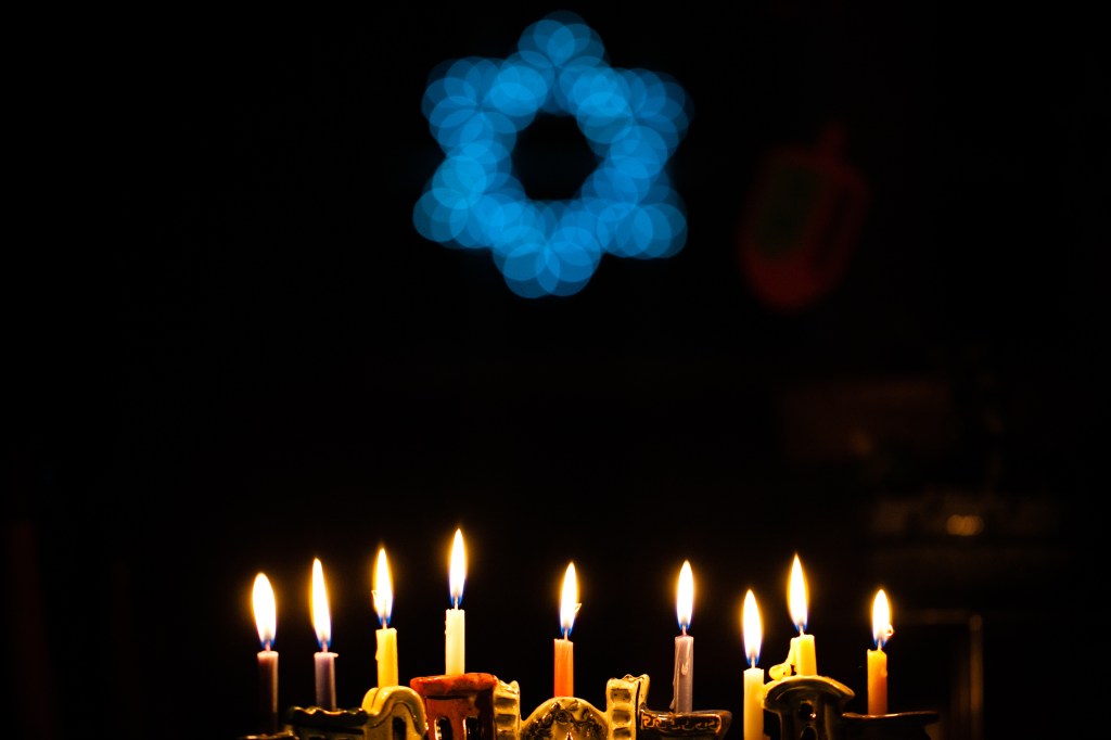 Menorah candlestick and Jewish Star, two symbols of Hanukkah. Here are some ways to celebrate Hanukkah with your dog.