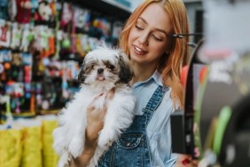A woman in a pet store with a dog, Vermont is going to ban pet store sales of dogs.