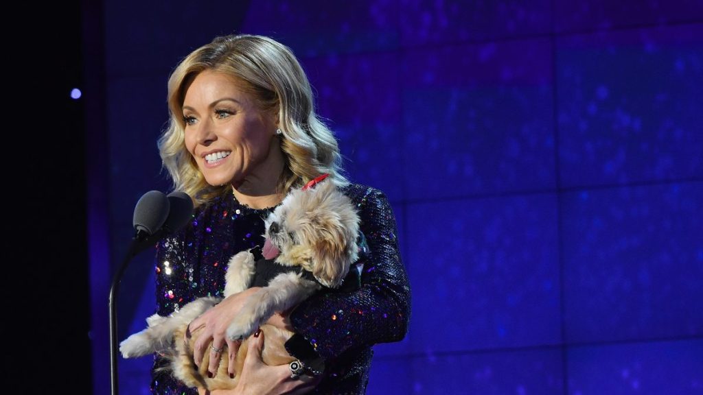 Talk host Kelly Ripa on stage carrying a dog, Kelly Ripa recently opened up about her senior dog's struggles