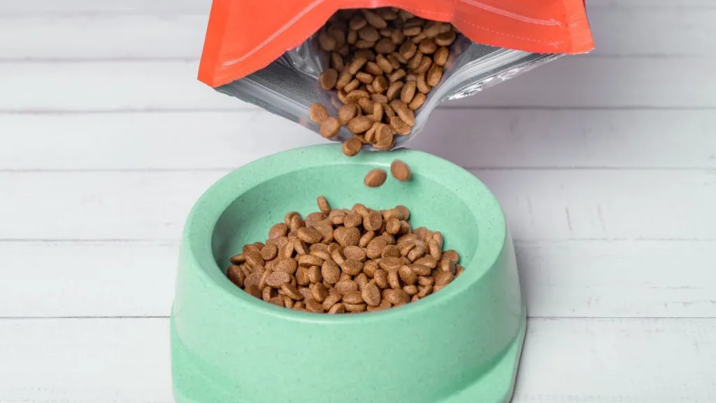 Pouring dog food into a bowl. Gentle Giants dog food recall.