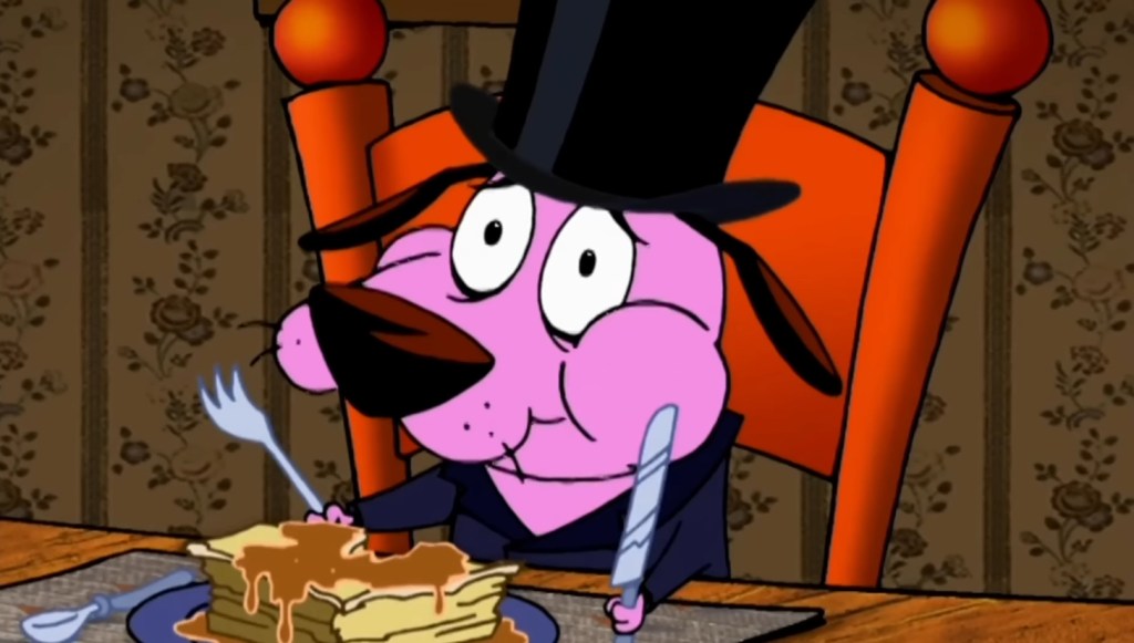 Courage the Cowardly Dog eating food with a knife and a fork in his hands.