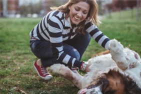 A woman playing with her dog, Forbes Advisor has released the best cities for pet owners in the United States.