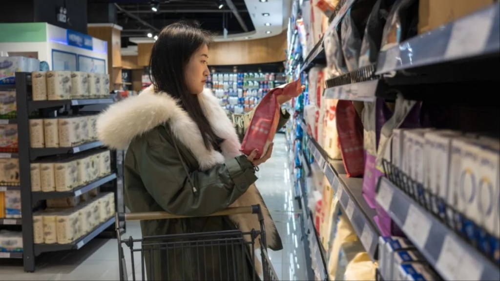 A young woman buying pet food, dog food has become expensive lately.