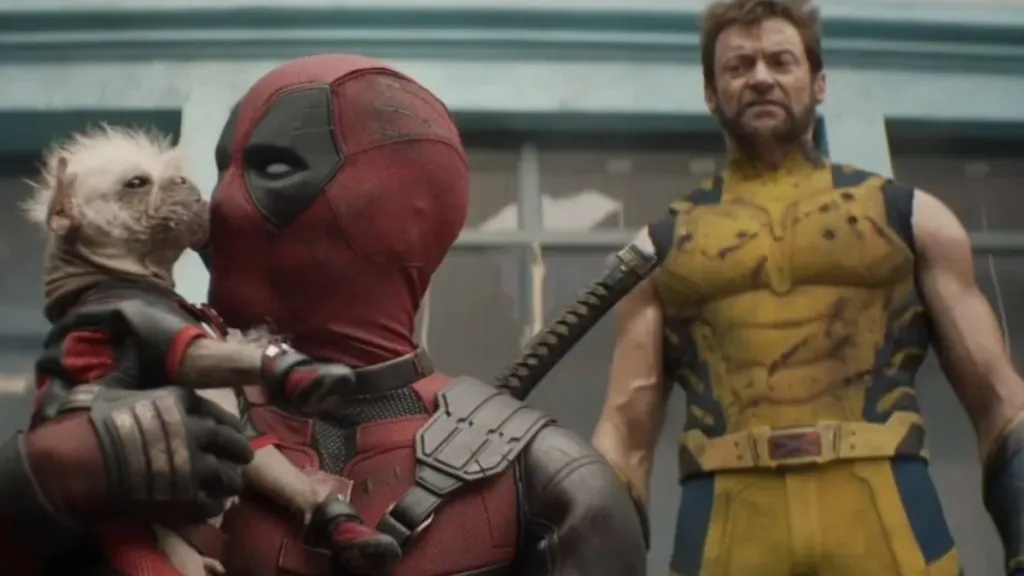 Deadpool holding “Dogpool” with Wolverine standing behind him.