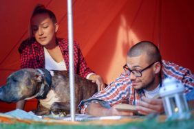 Couple in a tent with their dog