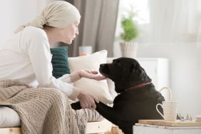 Cancer patient caressing her dog while on a pet therapy